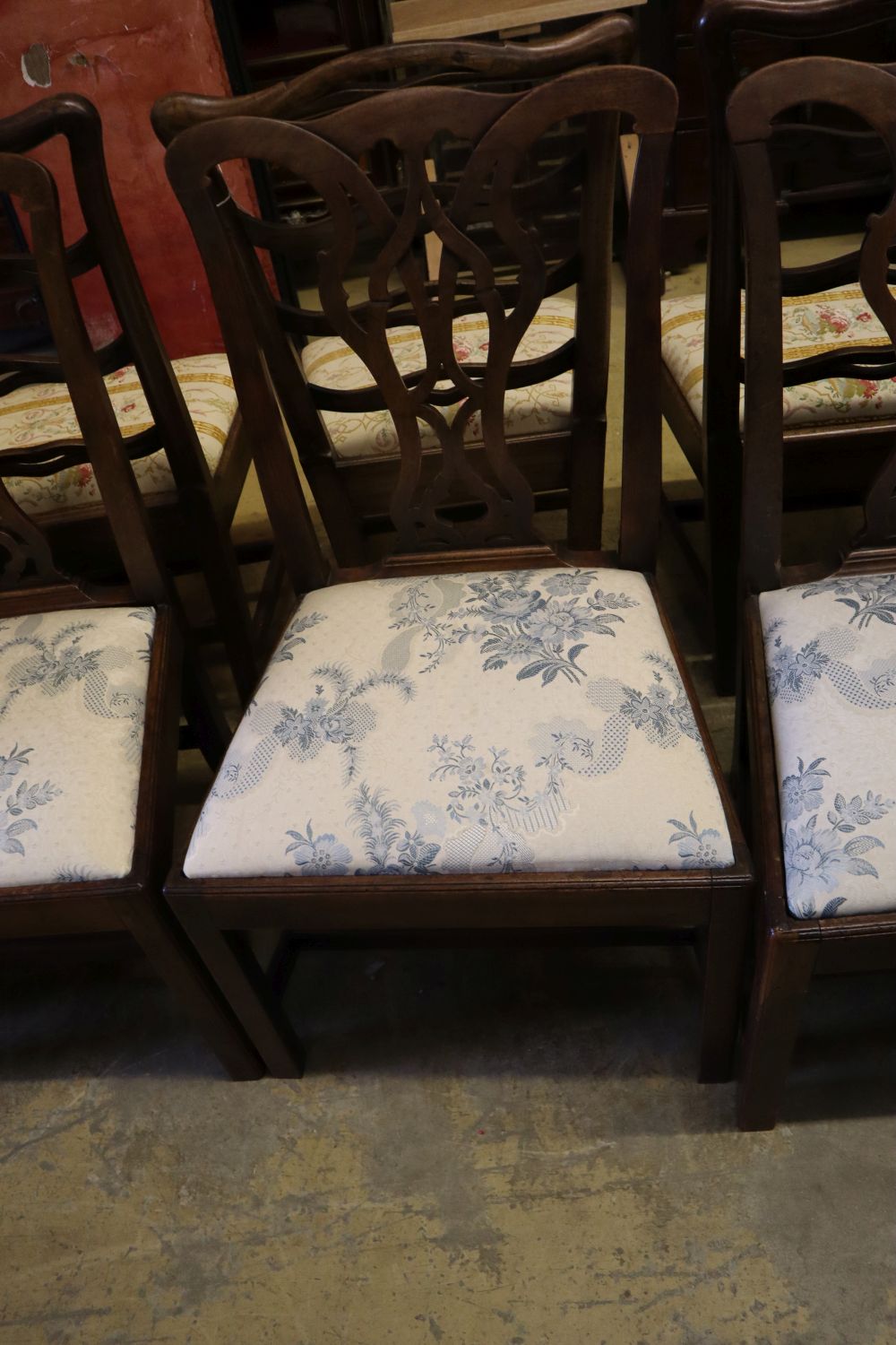 A set of three George III mahogany dining chairs with crewel-work seats and another set of three George III dining chairs (6)